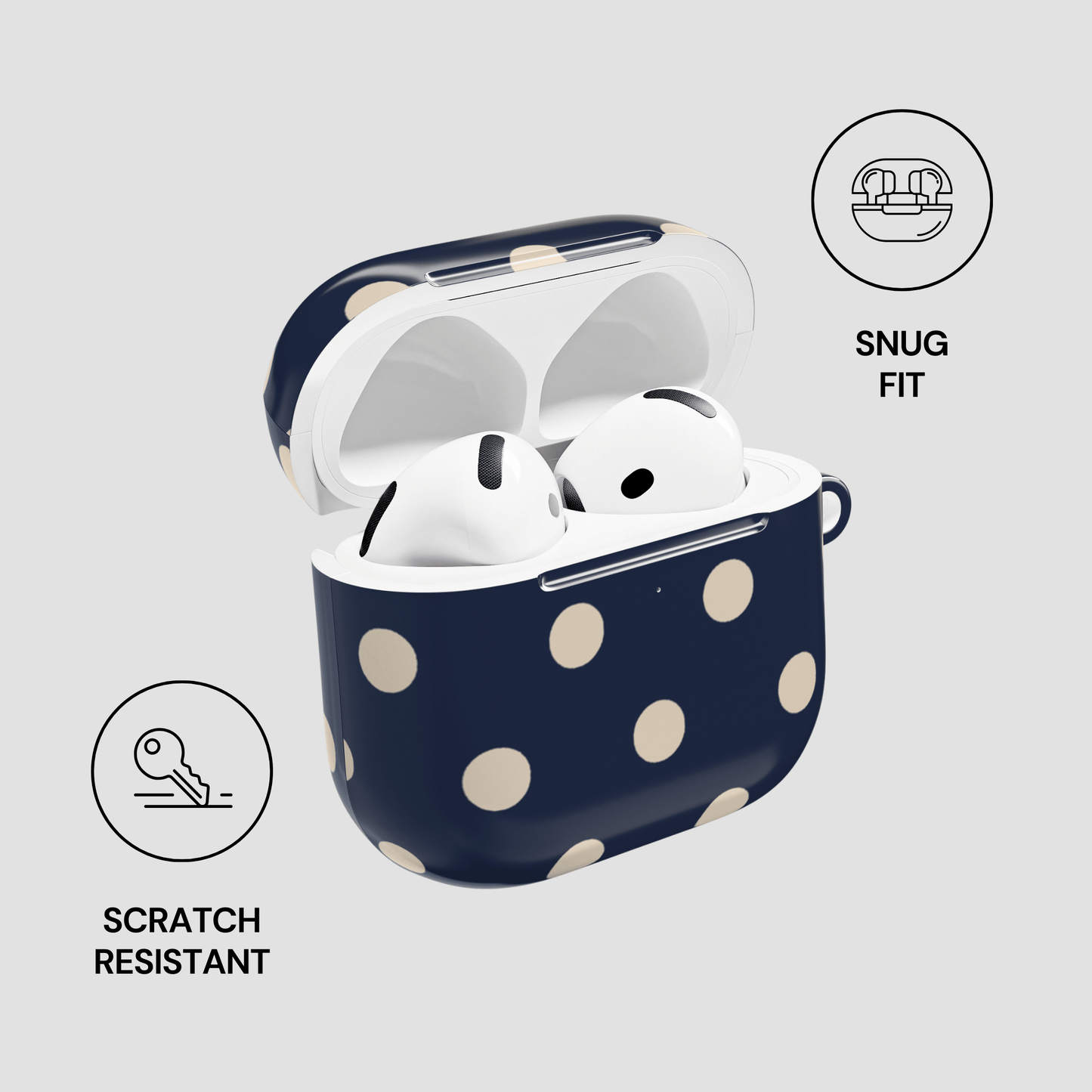 Navy blue case with white polka dots containing white wireless earbuds on a light gray background