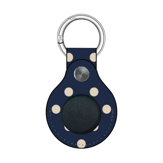 Navy blue keychain with white polka dots and a silver ring on a white background