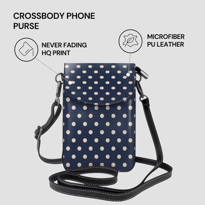 Navy crossbody phone purse with white polka dots on a light gray background