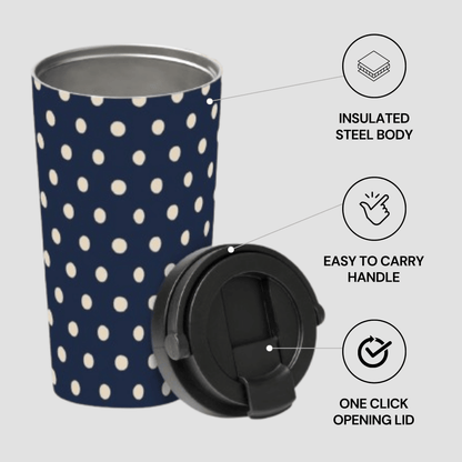 Navy blue tumbler with white polka dots and black lid on a light gray background