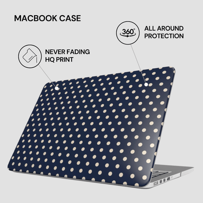 Navy blue MacBook case with white polka dots on a light gray background