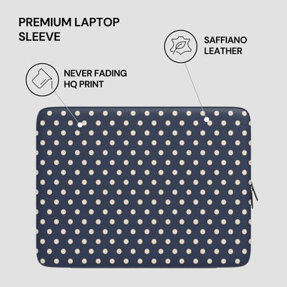 Navy blue laptop sleeve with white polka dots on a light gray background
