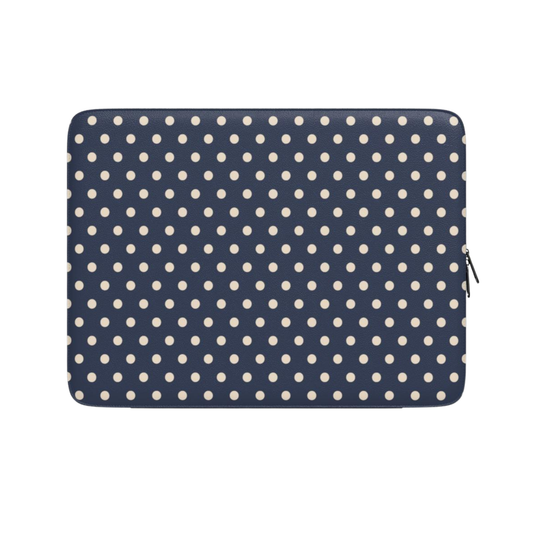 Navy blue laptop sleeve with white polka dots on a white background