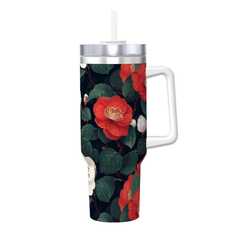 Tumbler with floral design featuring red flowers and green leaves on a white background