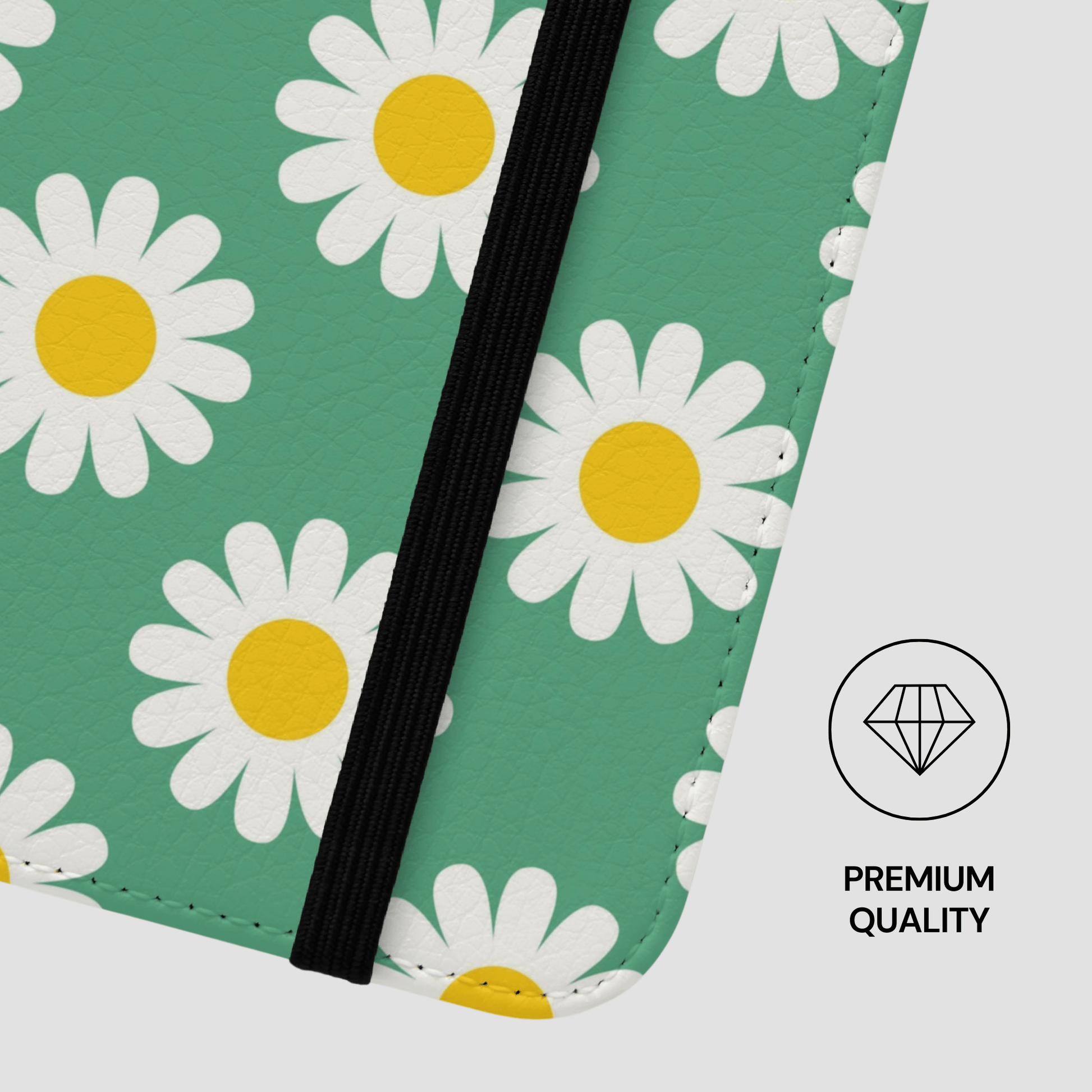 Notebook with daisy pattern on green cover and black binding, featuring a 'Premium Quality' diamond icon.