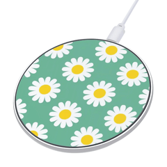 Wireless charging pad with daisy pattern on a green background