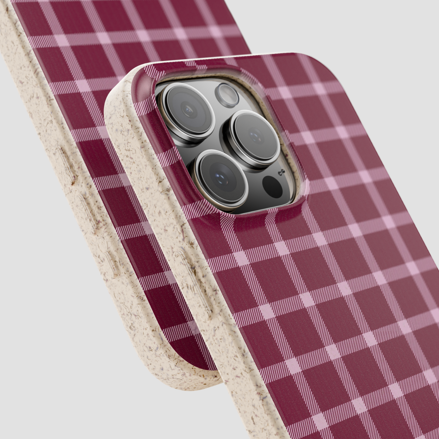 Phone case with red and white plaid pattern on a light gray background