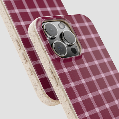 Phone case with red and white plaid pattern on a light gray background