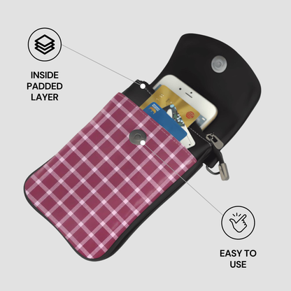 Black pouch with pink plaid interior holding a phone and cards, on a light gray background.