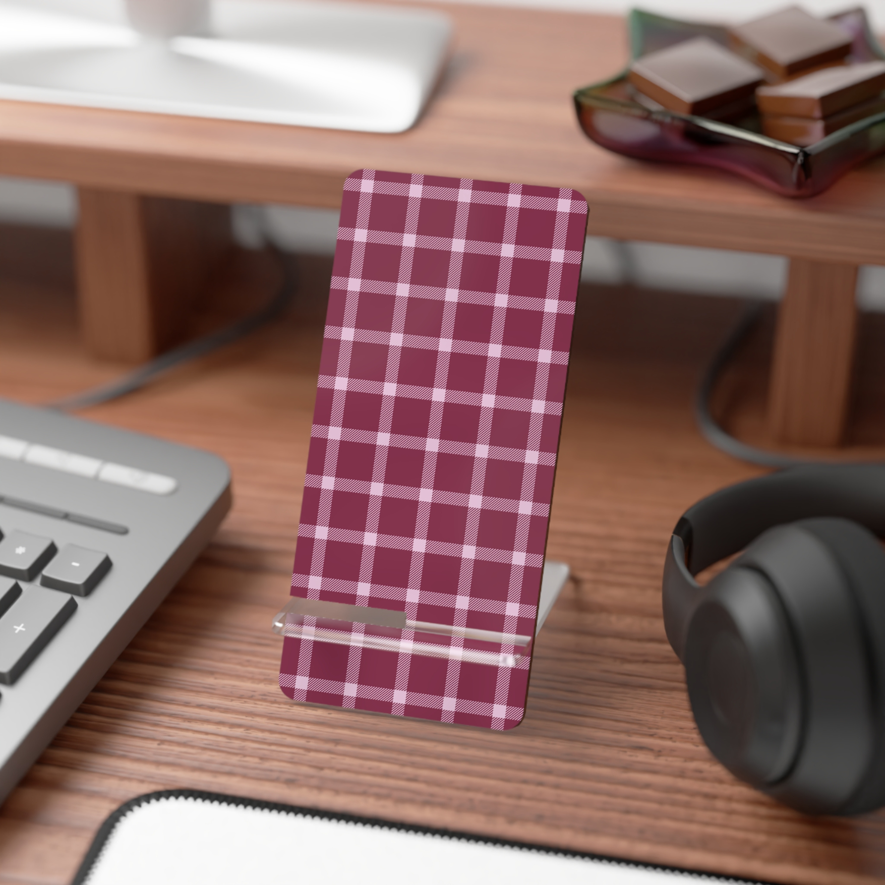 Plaid phone stand on a desk with keyboard, mouse, and sunglasses in the background