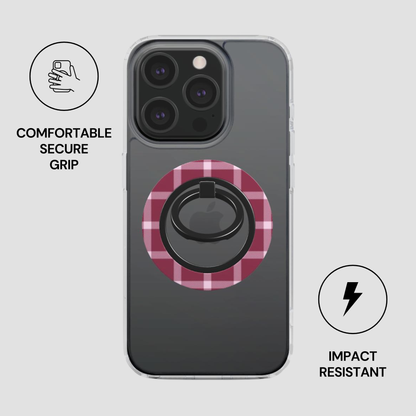Phone case with pink circular design and ring holder on a gray background
