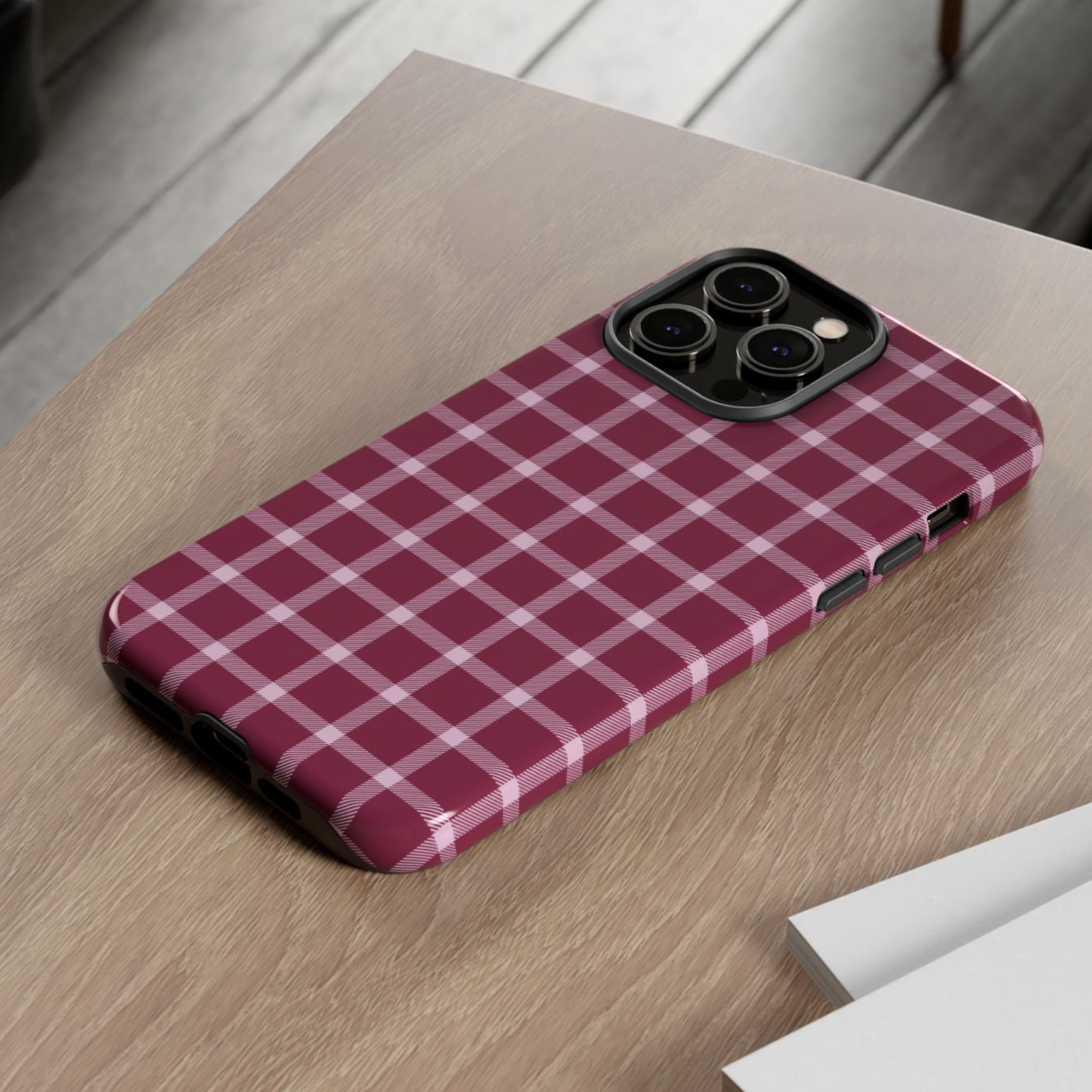 Red and white checkered phone case on a wooden surface
