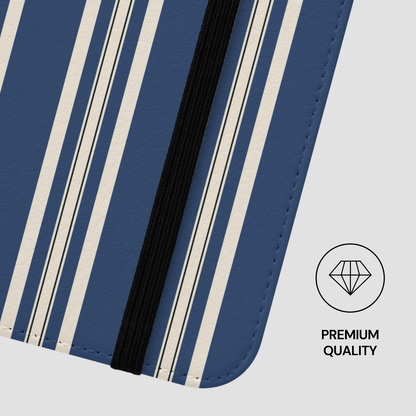 Close-up of a blue and white striped product with a black strip, on a light gray background.