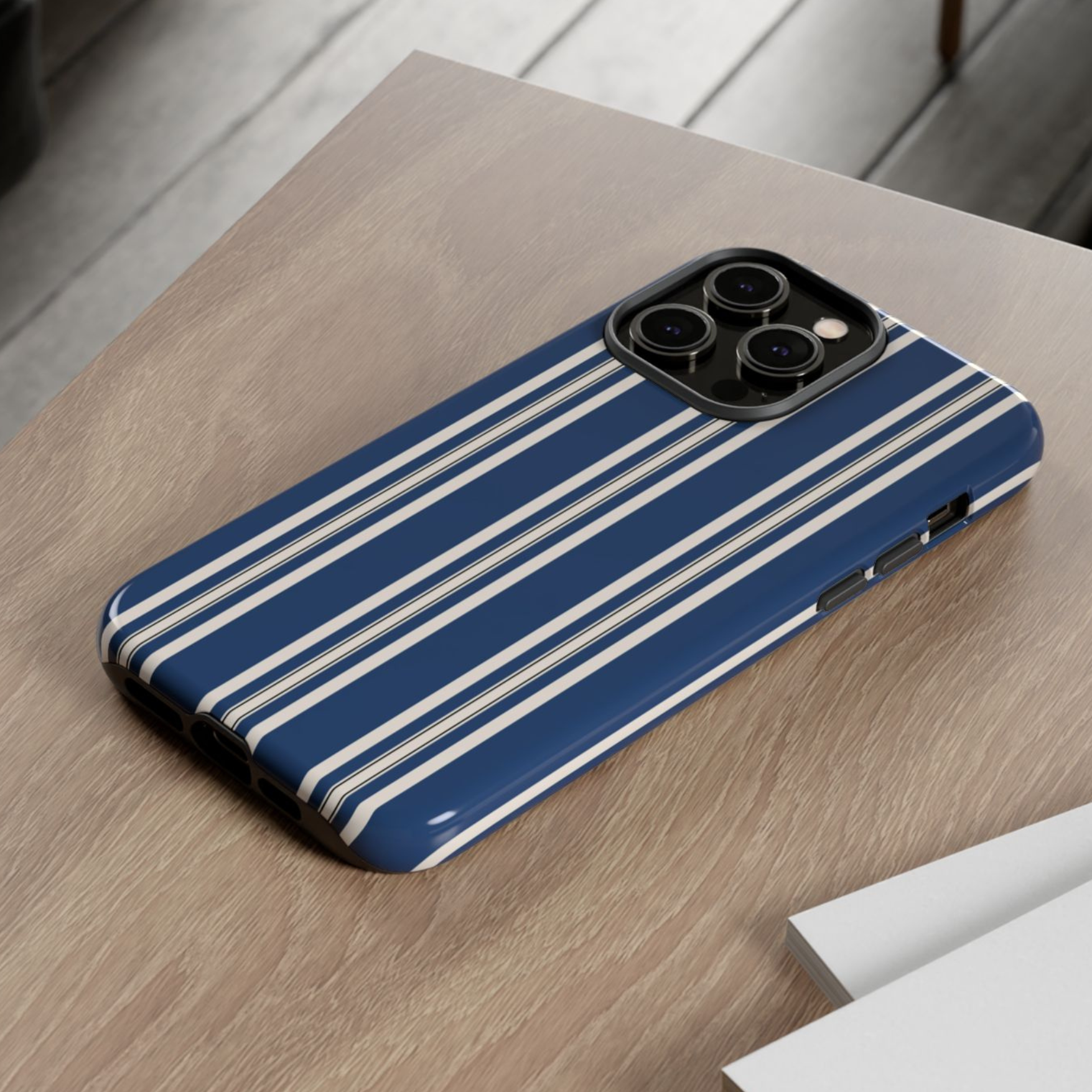 Blue phone case with white stripes on a wooden surface