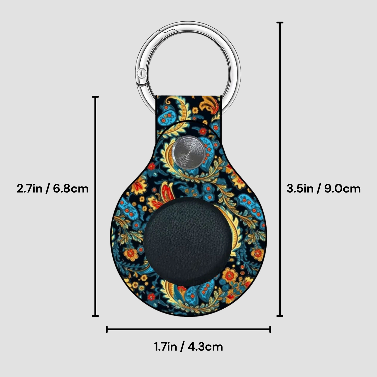 Decorative keychain with paisley pattern and measurements on a gray background