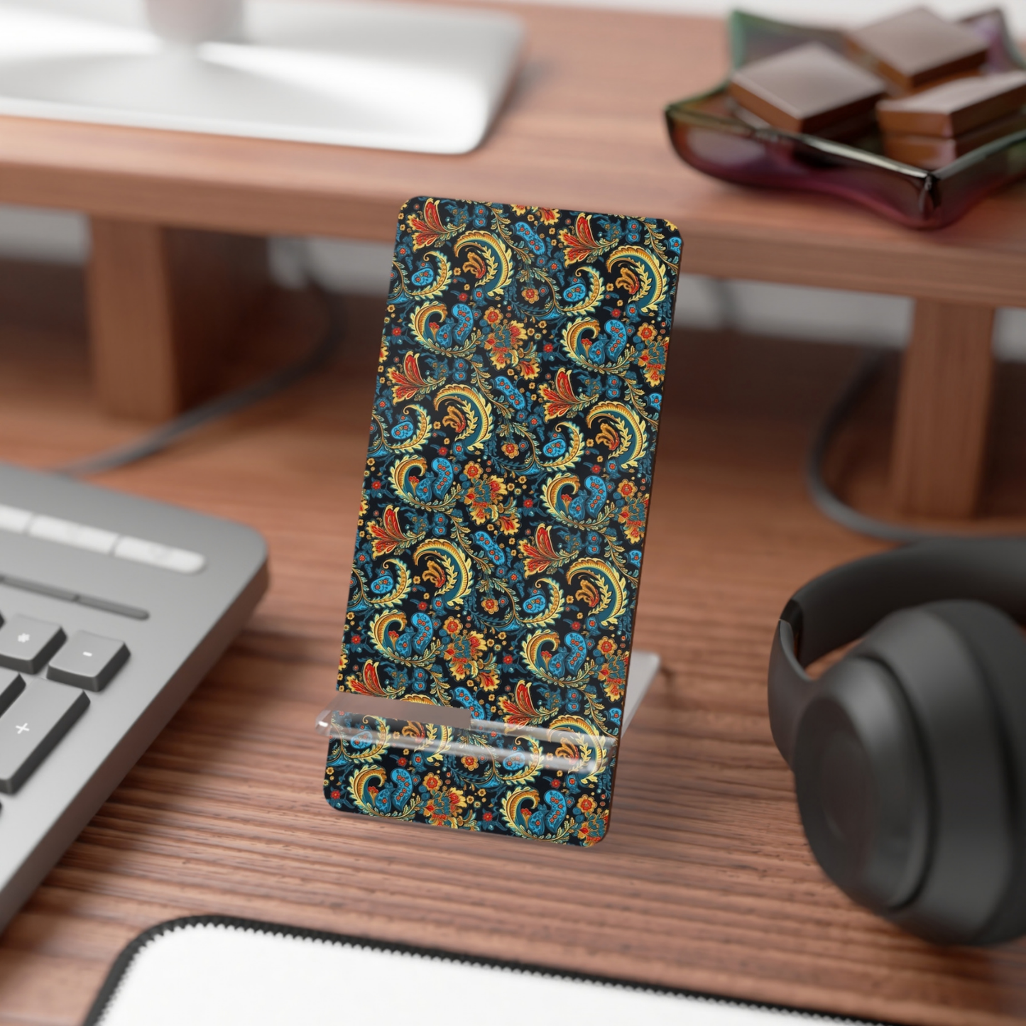 Phone case with colorful pattern on a desk with keyboard and headphones