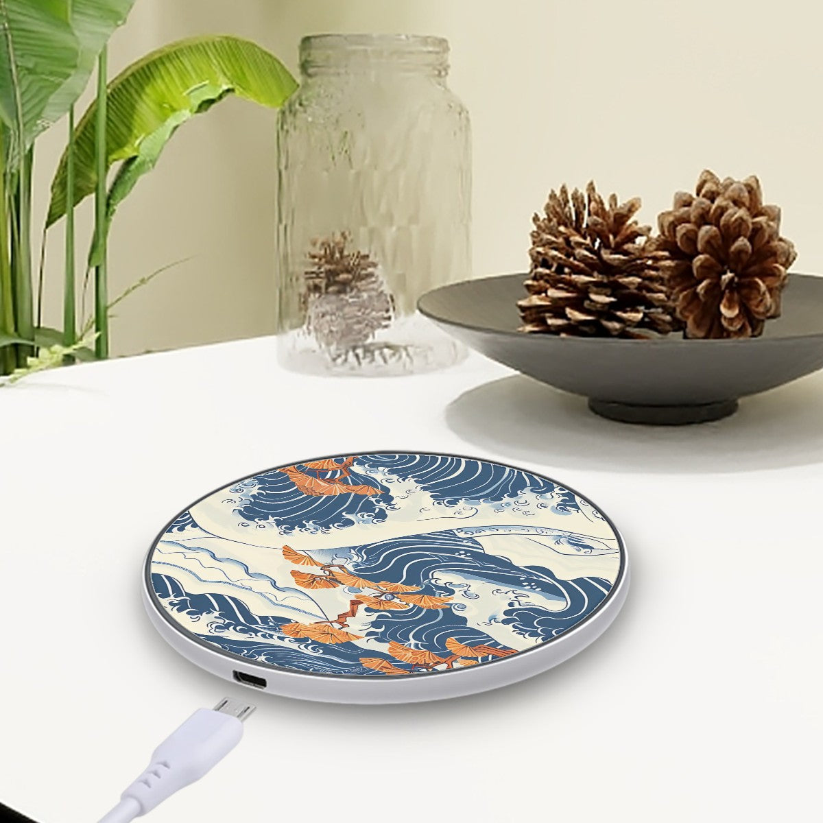 Wireless charger with wave and dragon design on a table with decorative items. | Casenari