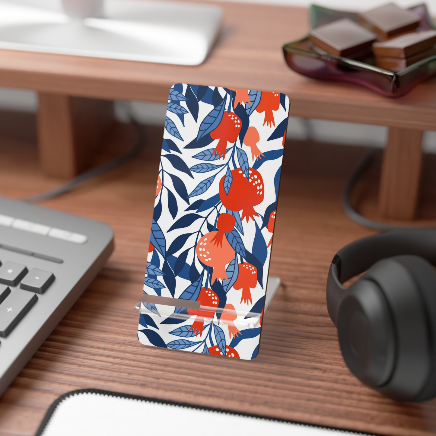 Phone case with floral design on a desk with computer and headphones