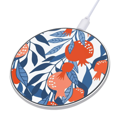 Wireless charging pad with pomegranate and leaf pattern on a white background