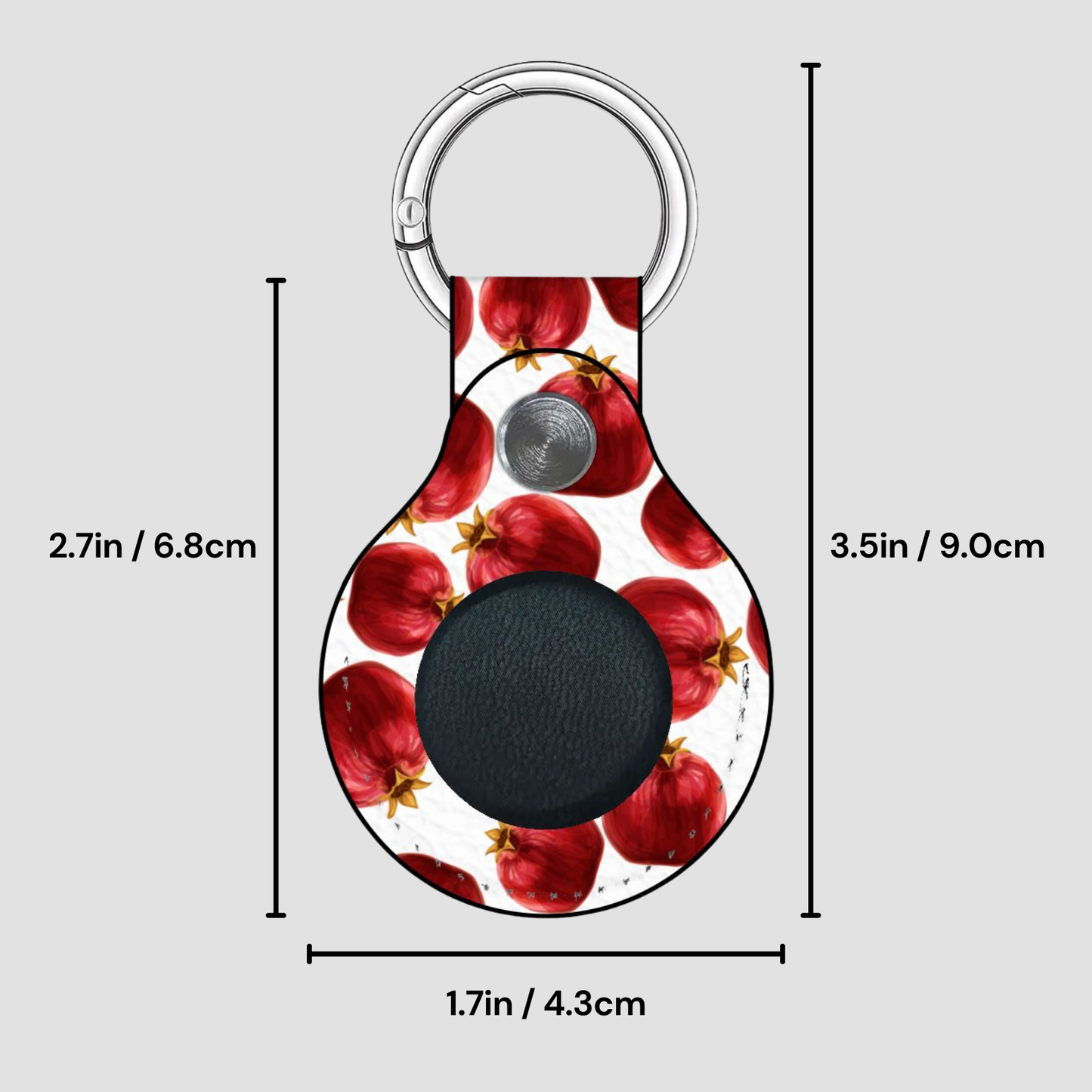 Keychain with pomegranate pattern and measurements on a gray background