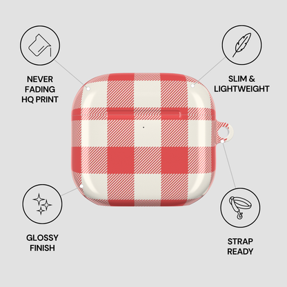 A red and white checkered protective case for wireless earbuds, shown on a light gray background with four feature callouts: never fading HQ print, slim and lightweight, glossy finish, and strap ready.