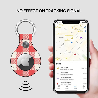 A red and white checkered keychain tracker with a silver key ring and a black circular chip, shown next to a hand holding a smartphone displaying a map with a key finder list. Text at the top reads 'NO EFFECT ON TRACKING SIGNAL'.