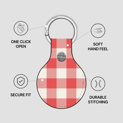 A red and white buffalo check leather keychain holder with a silver metal carabiner ring, shown with feature callout icons and text on a light gray background.