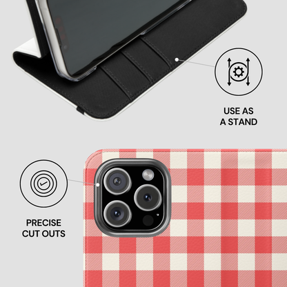 A phone case shown on a light gray background with feature callouts: a black folio-style stand at the top and a red-and-white gingham phone back at the bottom with text reading 'PRECISE CUT OUTS' and 'USE AS A STAND'.