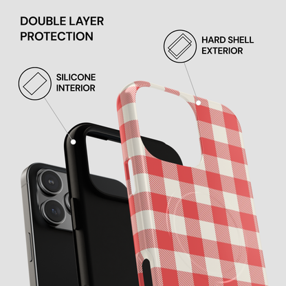 A phone case with a red and white gingham check pattern, shown layered over a black smartphone to demonstrate its hard shell exterior and silicone interior. The image includes text callouts highlighting key features: 'DOUBLE LAYER PROTECTION', 'HARD SHELL EXTERIOR', and 'SILICONE INTERIOR'.