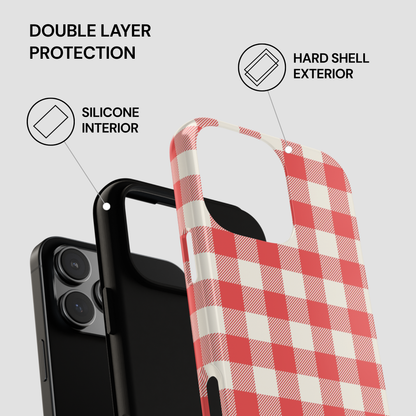 A phone case with a red and white gingham check pattern, shown layered over a black phone to demonstrate its double-layer protection design. The image includes text callouts pointing to the silicone interior, hard shell exterior, and double layer protection on a light gray background.