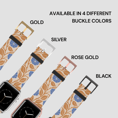 Four smartwatch bands with a beige floral leaf pattern and blue flower accents, shown with different buckle colors labeled Gold, Silver, Rose Gold, and Black on a light gray background.