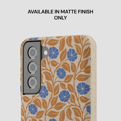 A phone case with a botanical pattern of blue flowers and brown leaves on a beige background, shown with a text overlay that reads 'AVAILABLE IN MATTE FINISH ONLY'.