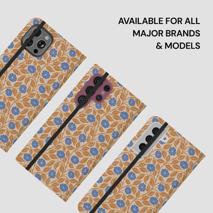 Three smartphone cases with a tan and blue floral pattern are shown on phones against a light gray background, with text reading 'AVAILABLE FOR ALL MAJOR BRANDS & MODELS'.
