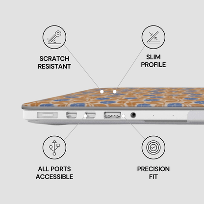 A close-up of the side of a laptop with a decorative patterned skin or cover in orange, blue, and white. Black text and icons around it highlight features: scratch resistant, slim profile, all ports accessible, and precision fit.