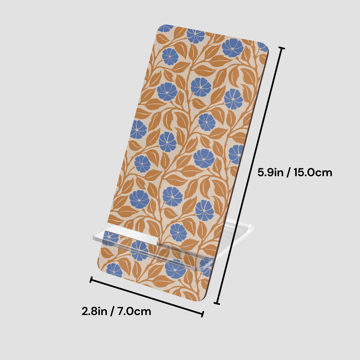 A rectangular phone stand with a floral pattern in blue and tan on a cream background, shown with dimension lines indicating 5.9 inches tall, 2.