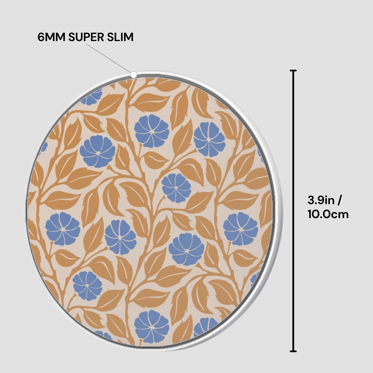 A circular coaster with a floral pattern in blue and tan on a cream background, shown with dimension lines indicating a height of 3.9 inches (10.