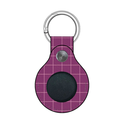 Purple grid-patterned keychain with a black circle and silver ring on a white background