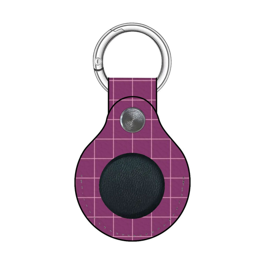 Purple grid-patterned keychain with a black circle and silver ring on a white background