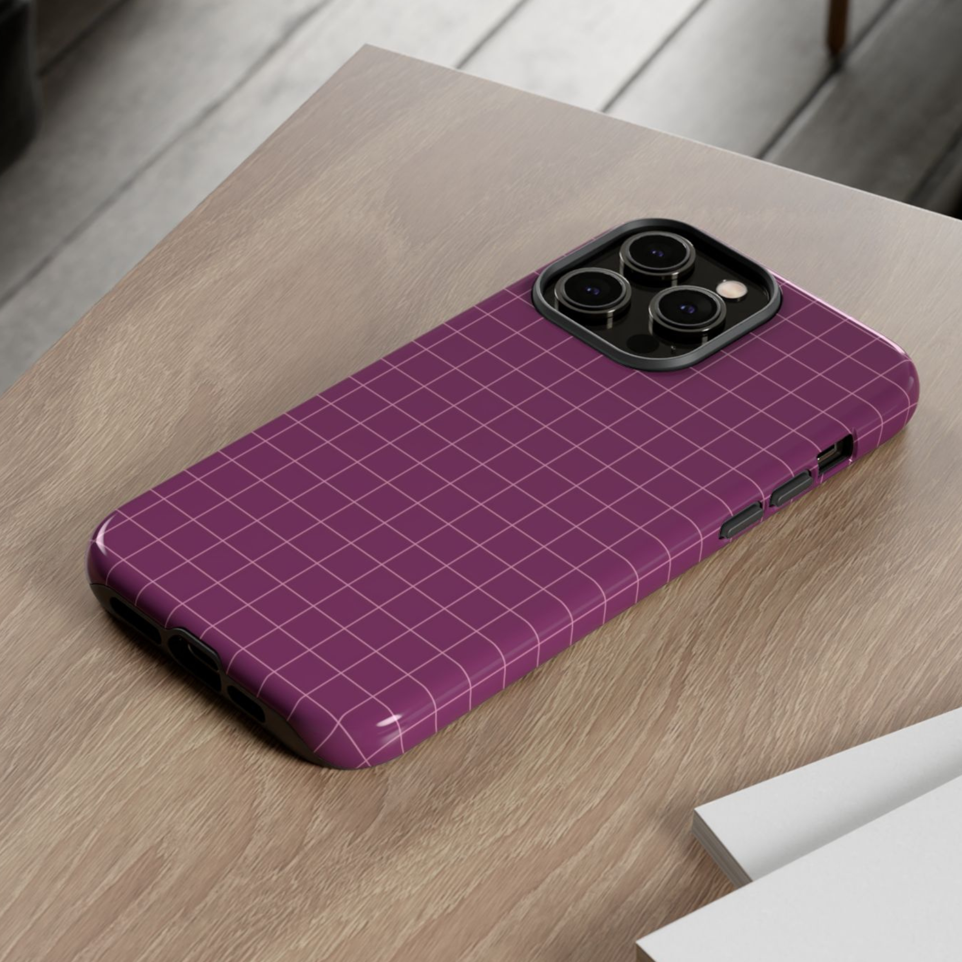 Purple grid-patterned phone case on a wooden surface