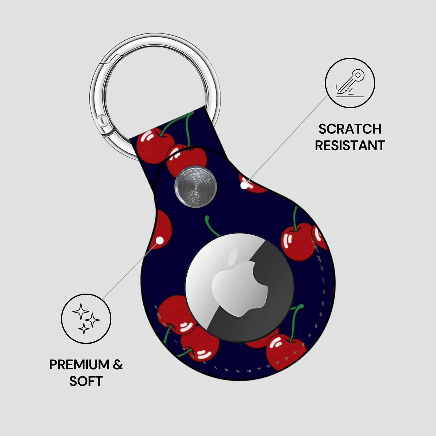 Keychain case with cherry design and Apple logo on a gray background