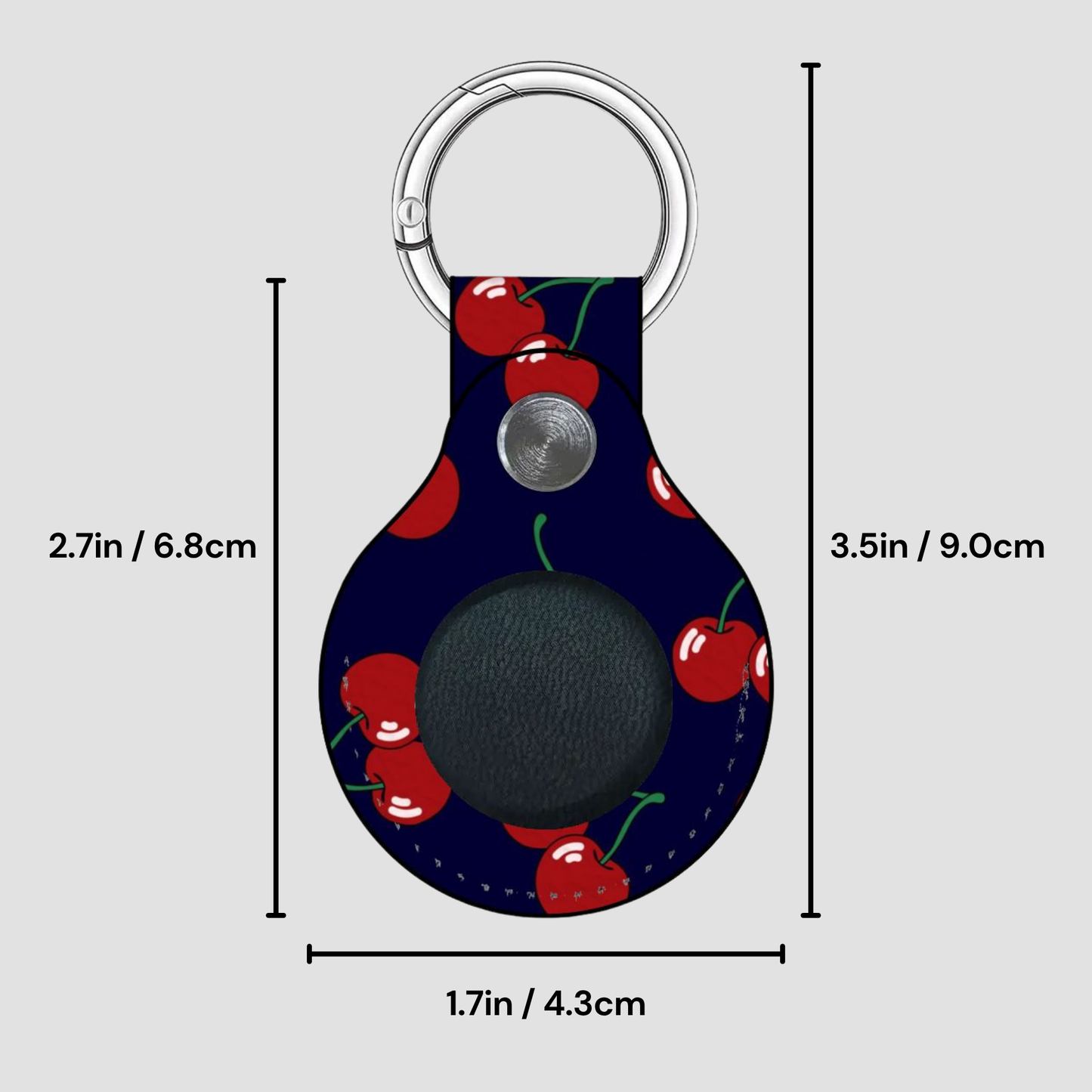 Keychain with cherry pattern and measurements on a gray background
