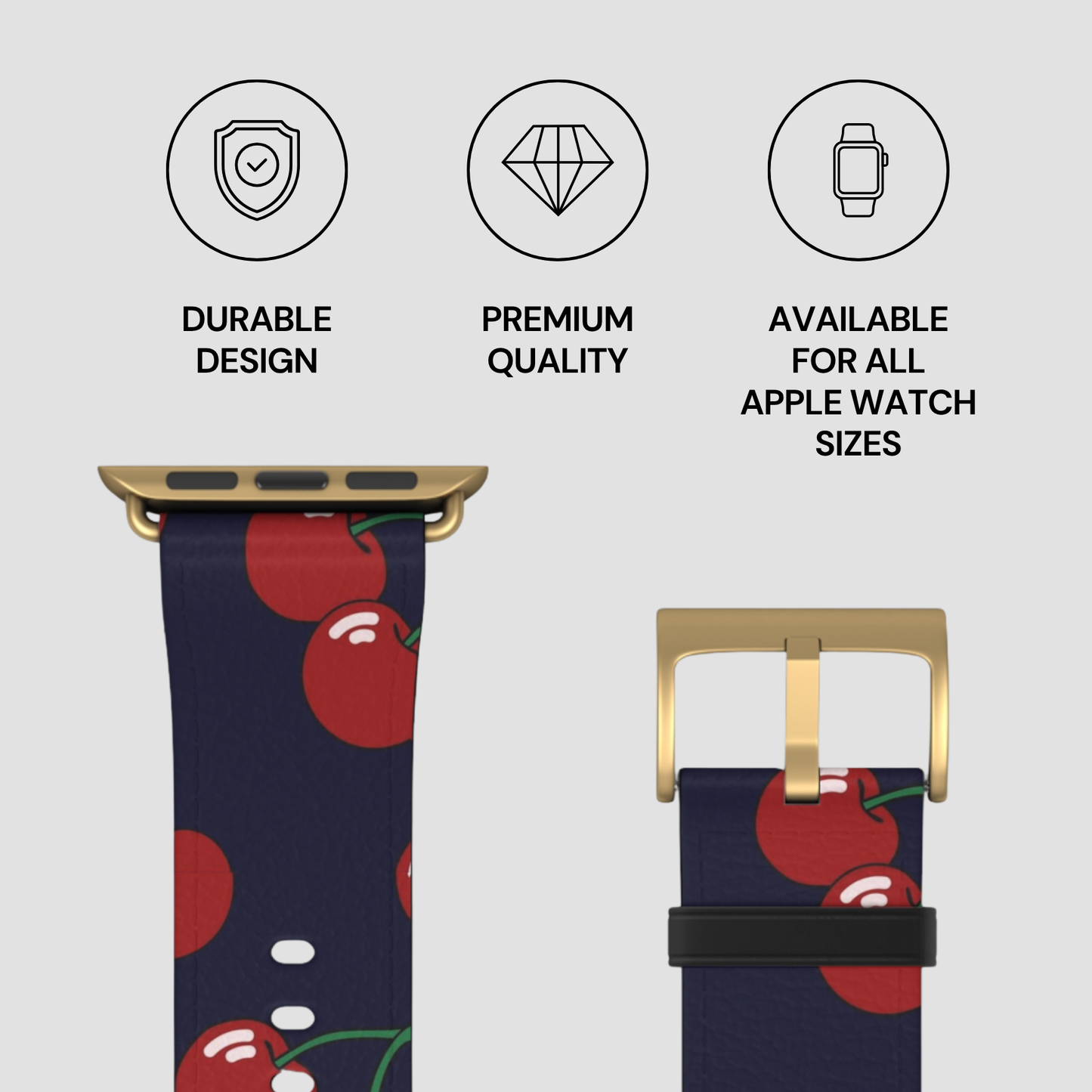 Watch strap with cherry pattern and gold buckle on a light gray background