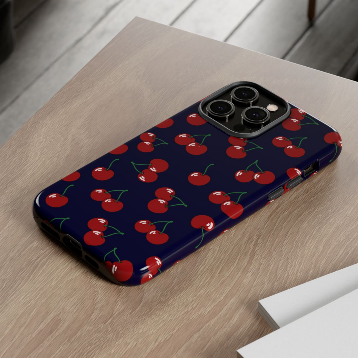 Phone case with cherry pattern on a wooden surface