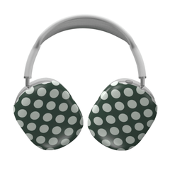 Green and white polka dot headphones on a white background