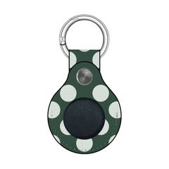 Green polka dot keychain case with a black circle on a white background