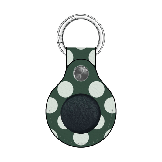 Green polka dot keychain case with a black circle on a white background