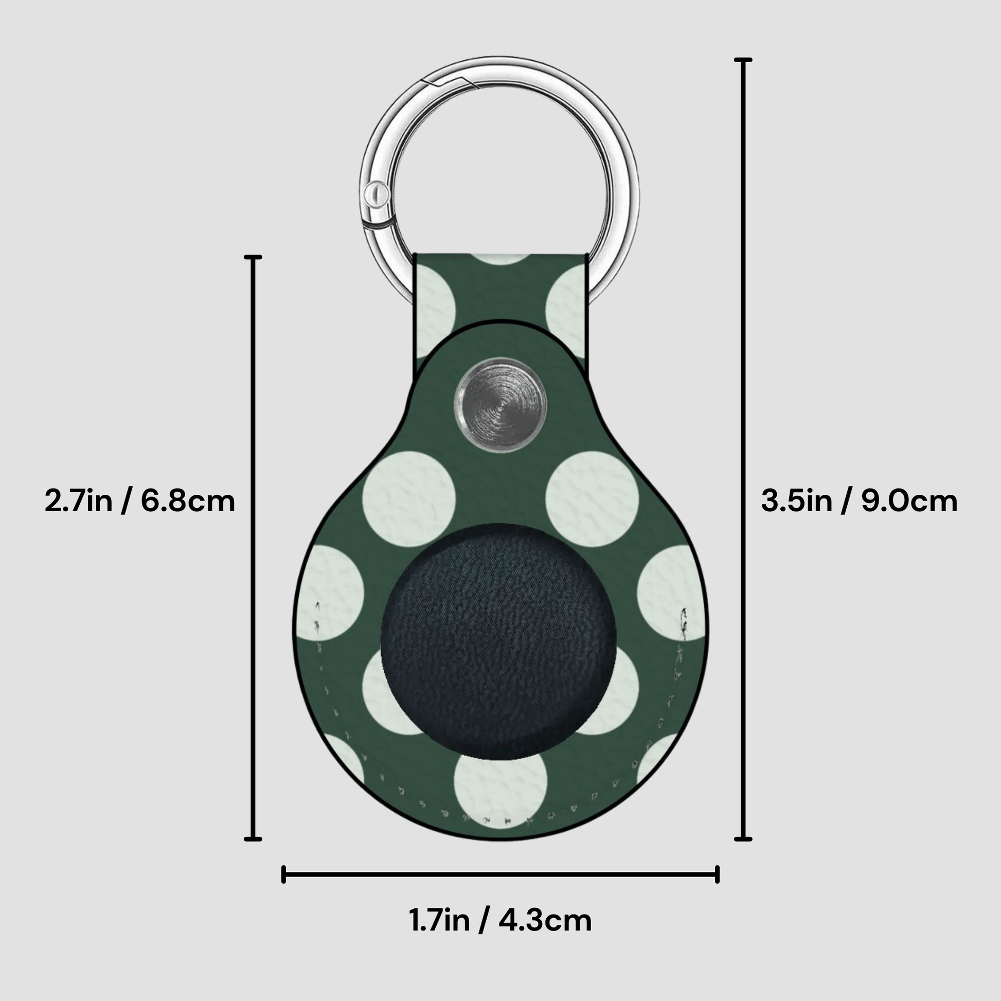 Green polka dot keychain with measurements on a gray background