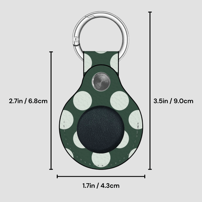 Green polka dot keychain with measurements on a gray background