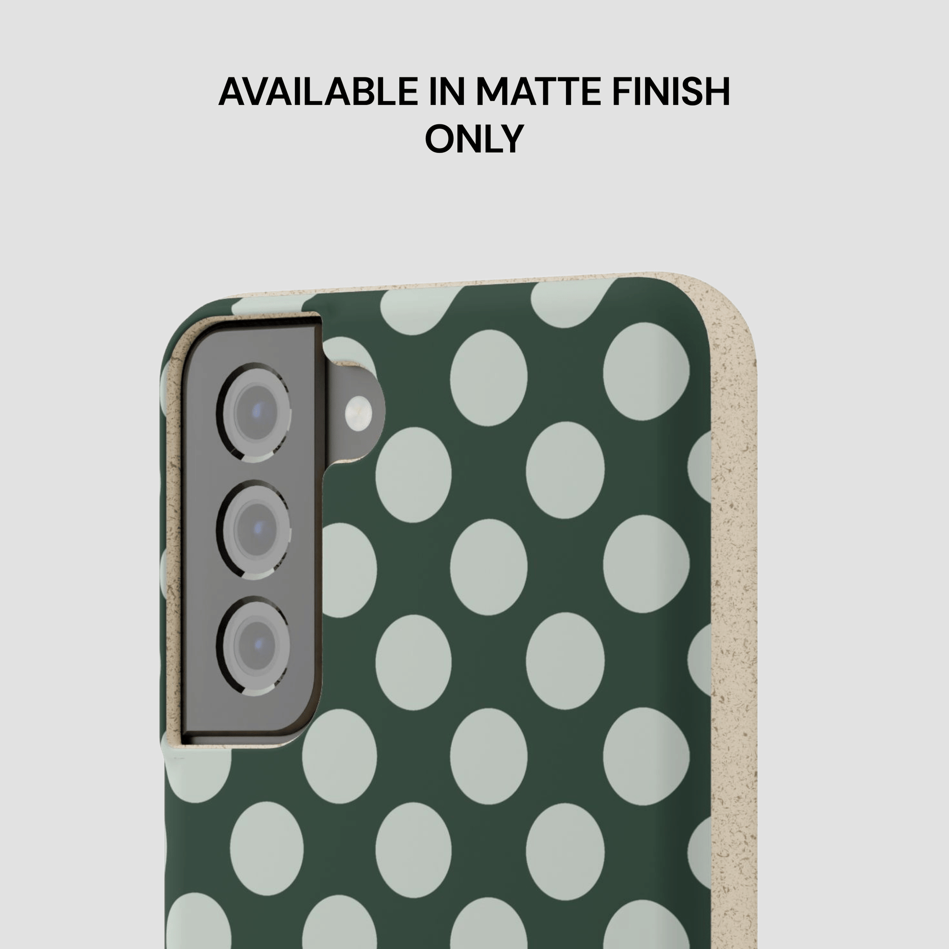 Phone case with green and white polka dot pattern on a light gray background
