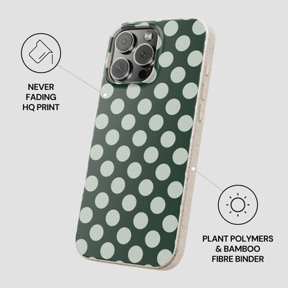 Green phone case with white polka dots on a light gray background